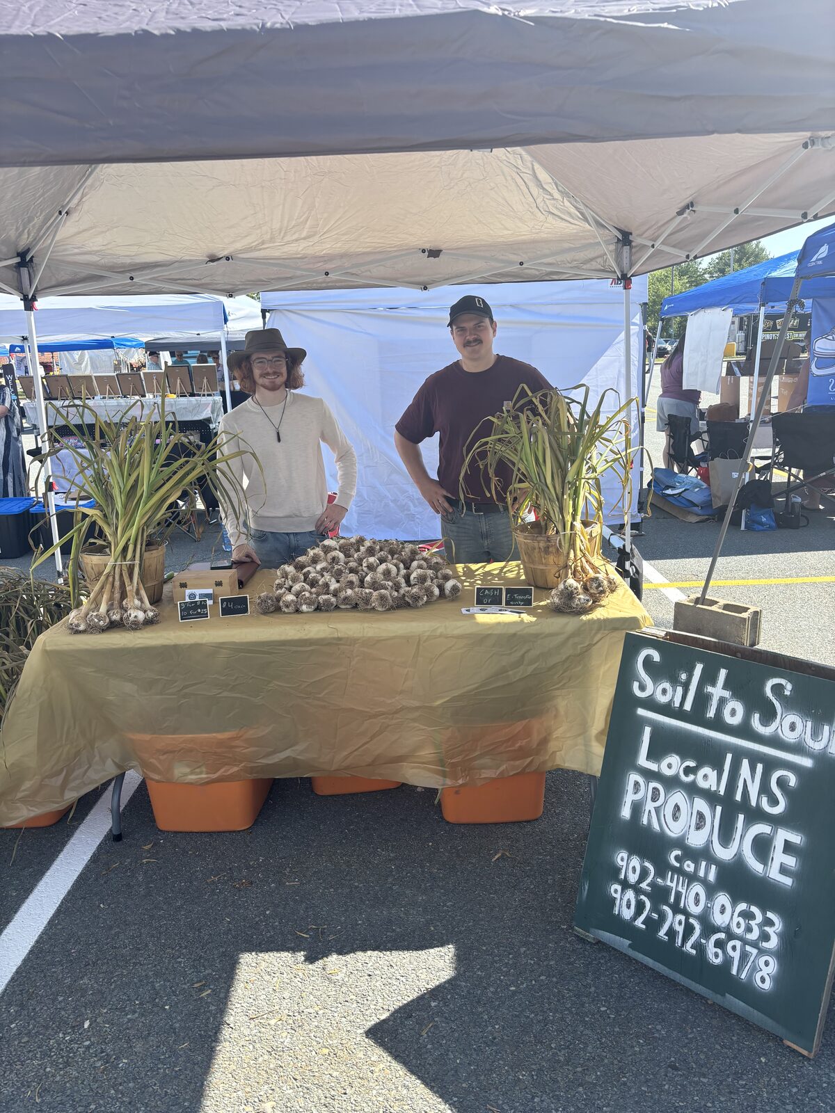 Kage Harris and Zac Ordinelli with Soil to Soul garlic at the East Hants market
